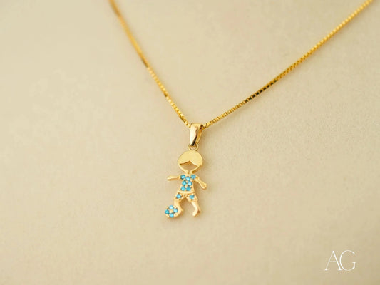 Gold pendant necklace in 18k yellow gold with stick figure charm and blue gemstones