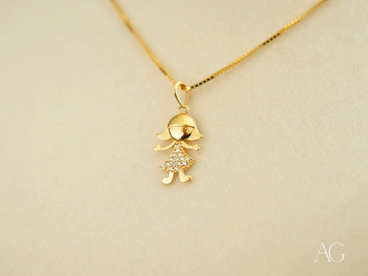 Gold pendant necklace featuring stylized doll design in 18k gold with crystal accents