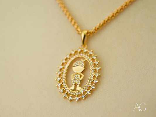 Gold pendant necklace featuring a boy design in 18k gold surrounded by crystals