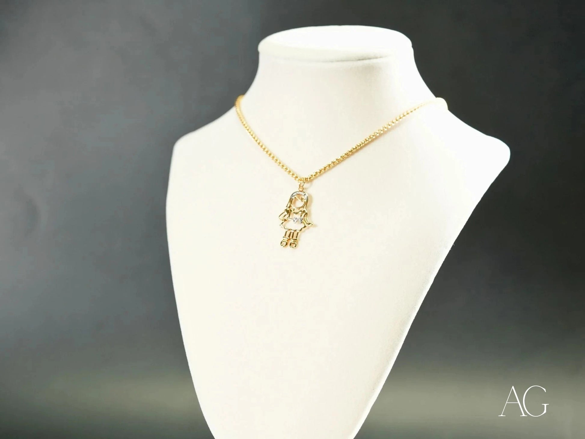 Gold Hamsa hand pendant necklace on white bust, part of Golden Cherish line