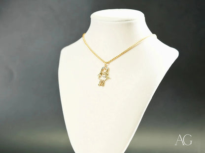 Gold Hamsa hand pendant necklace on white bust, part of Golden Cherish line