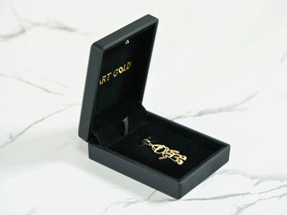 Black jewelry box showcasing the Golden Cherish Pendant with a gold-colored brooch