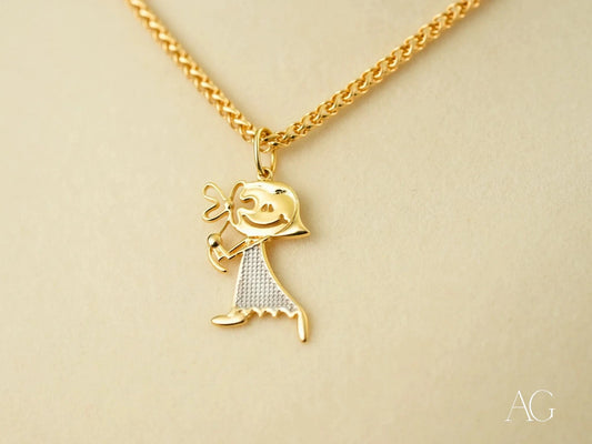 Gold Doll Pendant featuring a stick figure charm in 18k gold with textured dress pattern