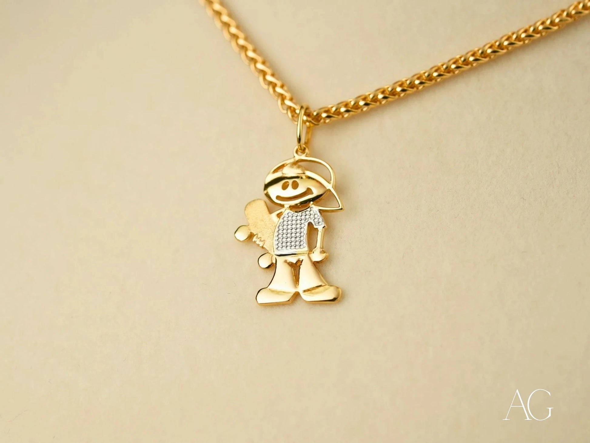 Gold Doll Pendant showcases a cartoon boy character in 18k gold with diamond accents