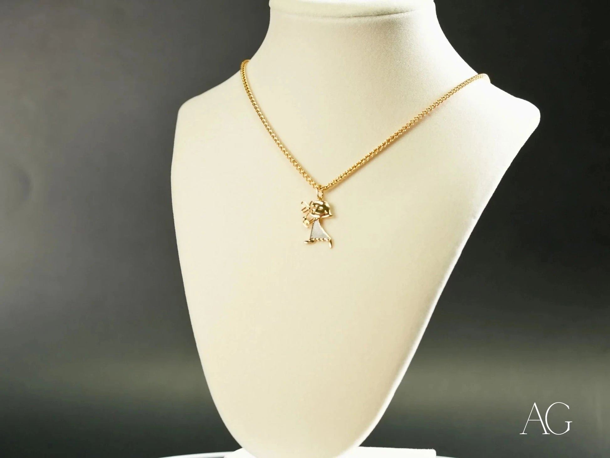 Gold-toned 18k Gold Golden Elegance Pendant with bow displayed on white jewelry bust