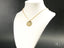 Gold-toned 18k gold pendant necklace with circular medallion, Golden Faith, Tudo Posso