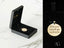 Gold-colored Tudo Posso pendant in black box, part of Golden Faith collection in 18K gold