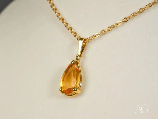 Teardrop-shaped amber pendant with yellow topaz on a delicate 18k gold chain necklace