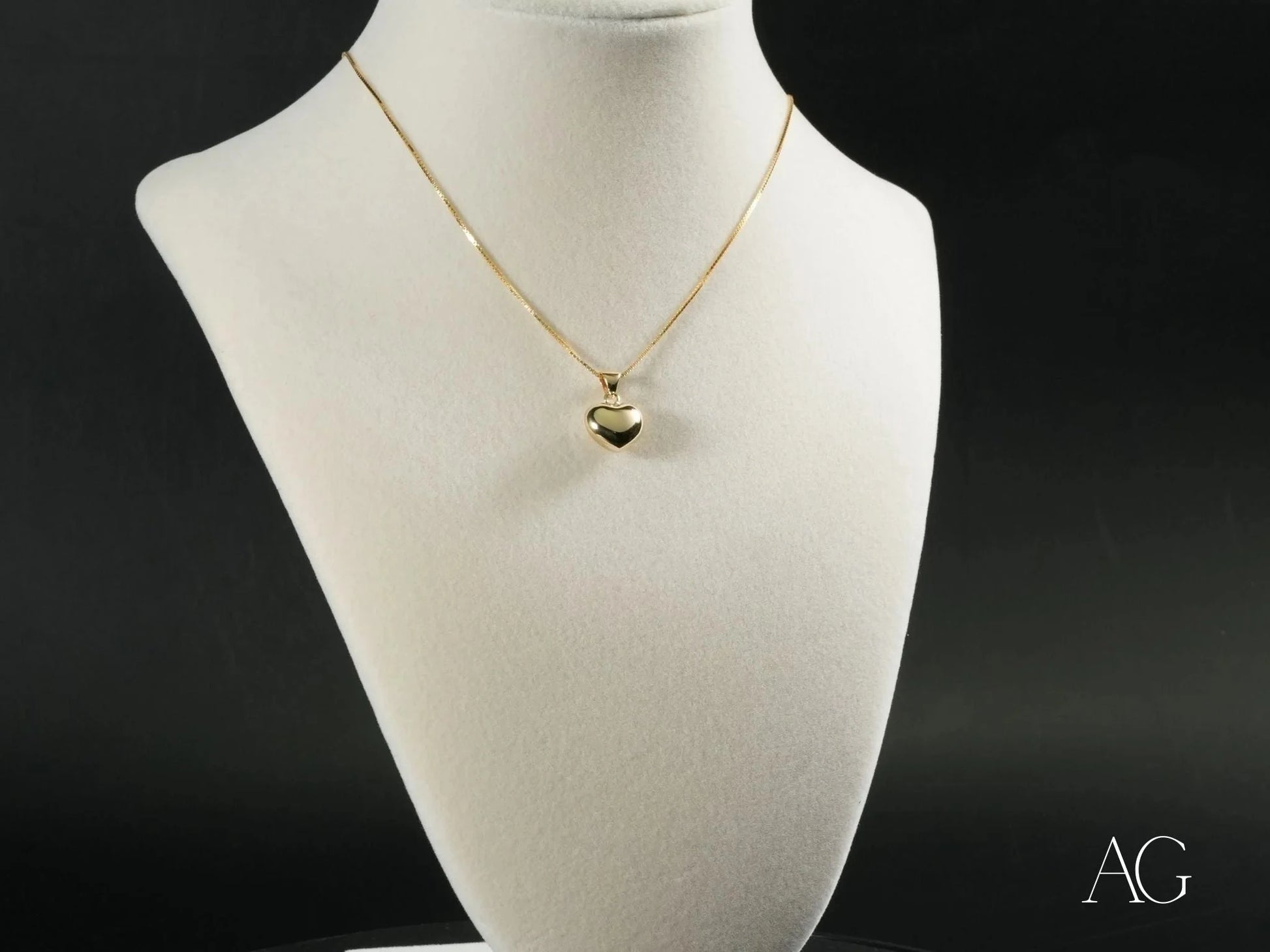 Elegant 18k gold heart pendant necklace on a white bust showcasing Golden Heart design