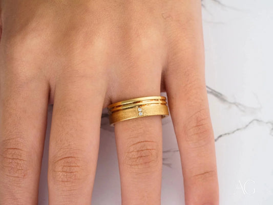 Gold wedding band set with diamond accent, featuring 14k gold craftsmanship