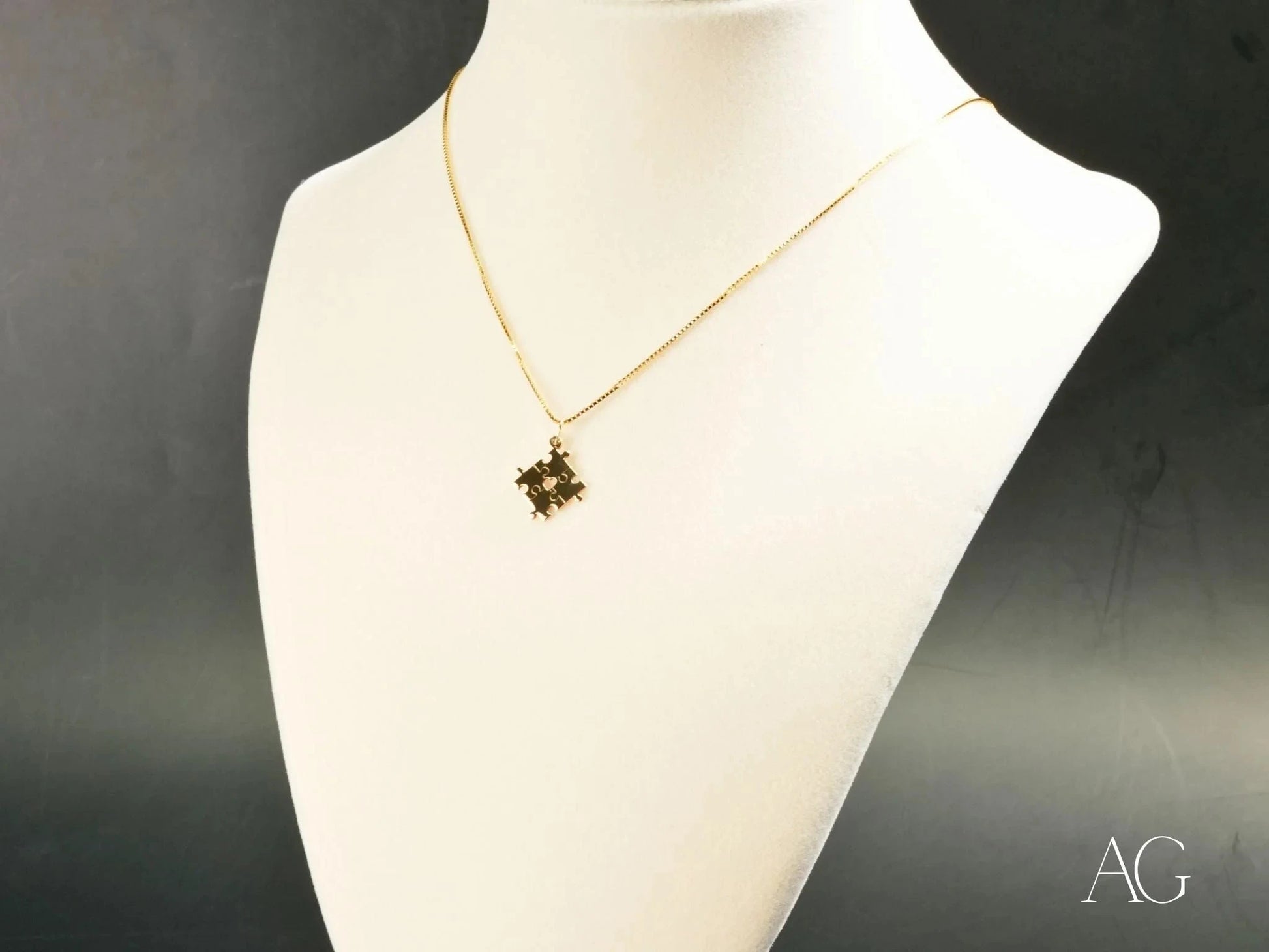 Gold necklace with 18k gold autism awareness puzzle piece pendant on white bust