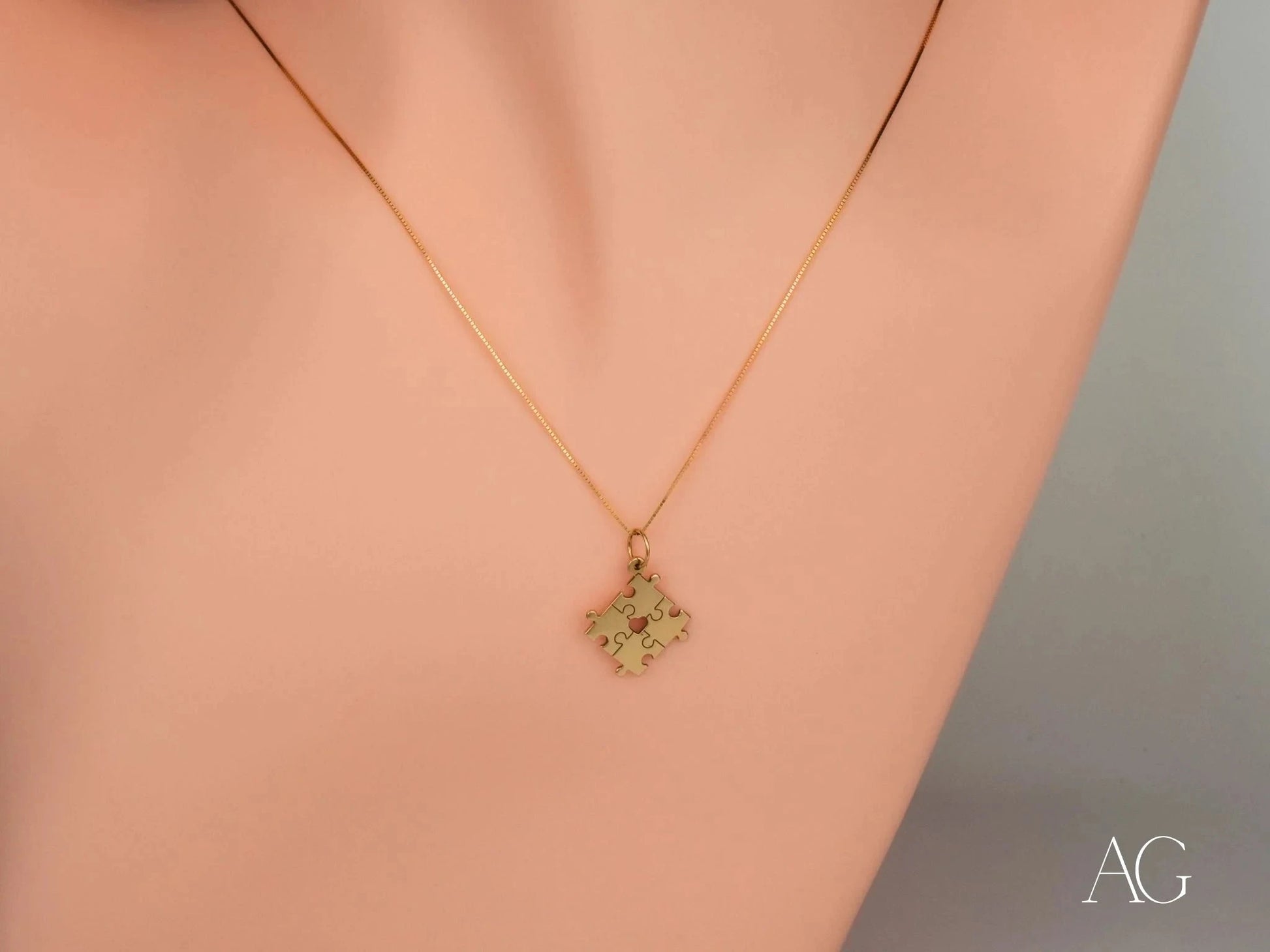 Gold necklace featuring a puzzle piece pendant for autism awareness and support
