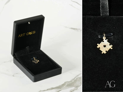 Gold puzzle piece pendant in a black box for Autism Awareness in 18k gold