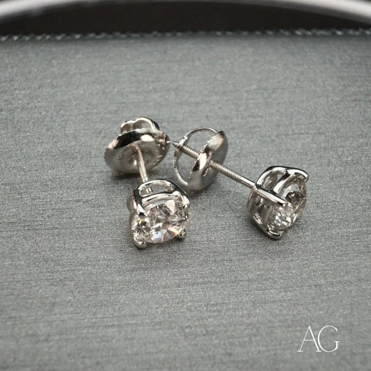 Pair of diamond stud earrings in 18k white gold prong settings, Radiant collection