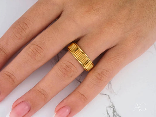 Gold 14k Regal Ridge Wedding Band with a textured ribbed design worn on a finger
