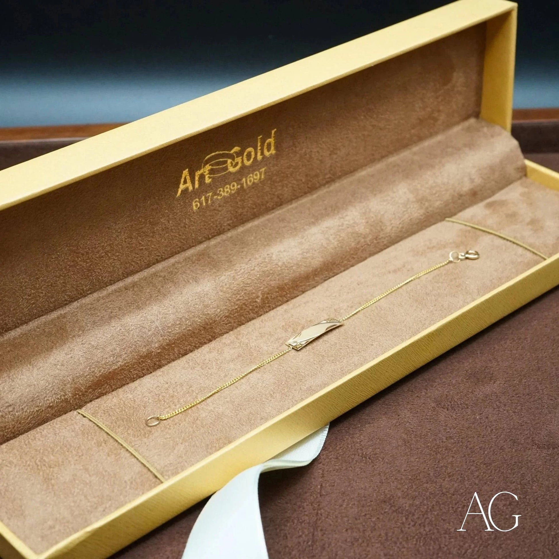 Gold bracelet in an open jewelry box showcasing Timeless 18k solid gold id bracelet for kids