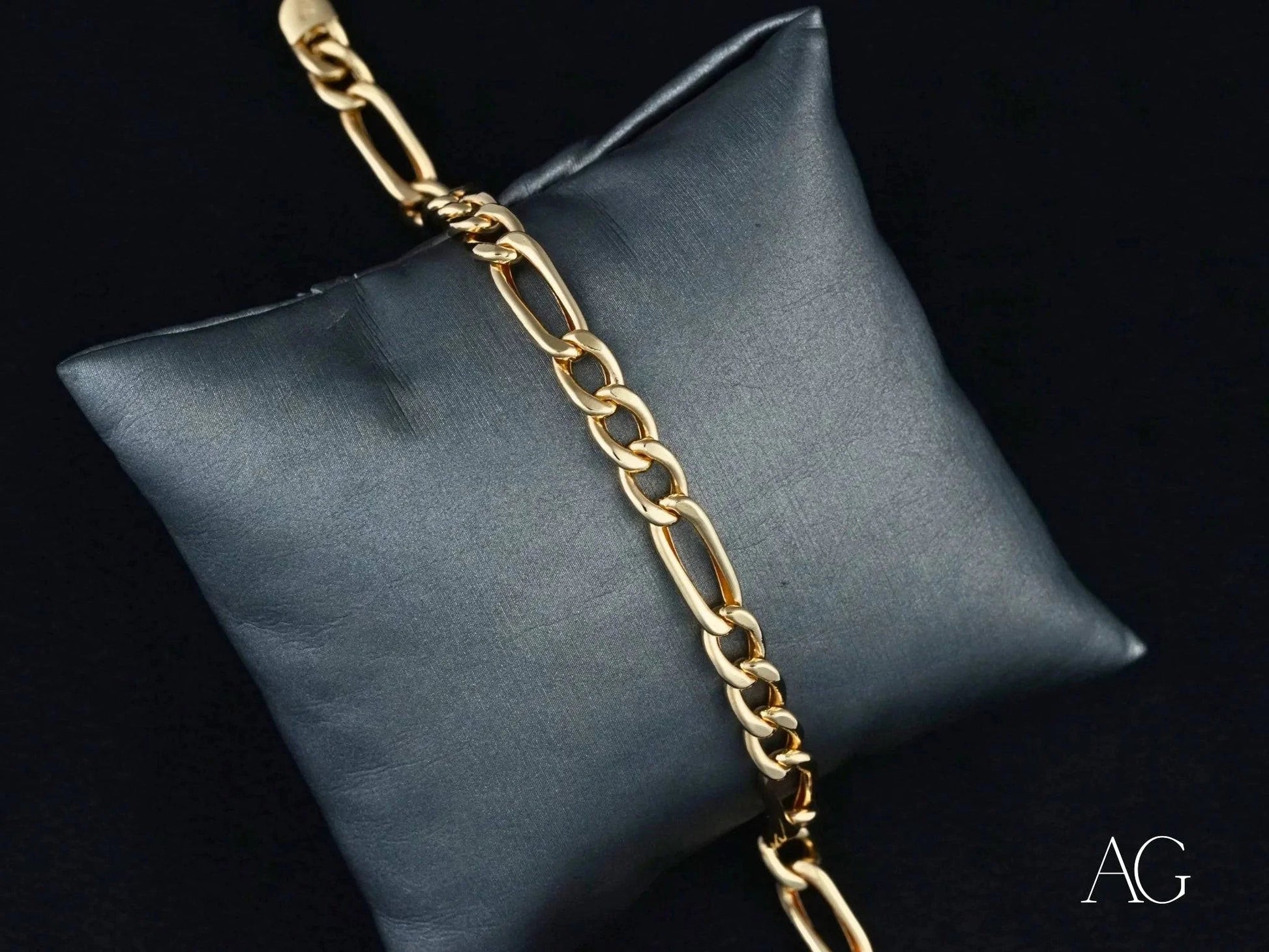 Gold Chain Bracelet on Dark Cushion for Timeless Love 18k Gold Figaro Bracelet