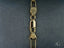Gold lobster clasp on a box link segment of the 18k solid gold bracelet