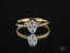Twist of Brilliance Engagement Ring featuring an oval diamond on an 18k gold band
