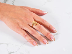 Gold Butterfly Ring on a manicured hand showcasing the Blossom Charm 18k Gold Ring