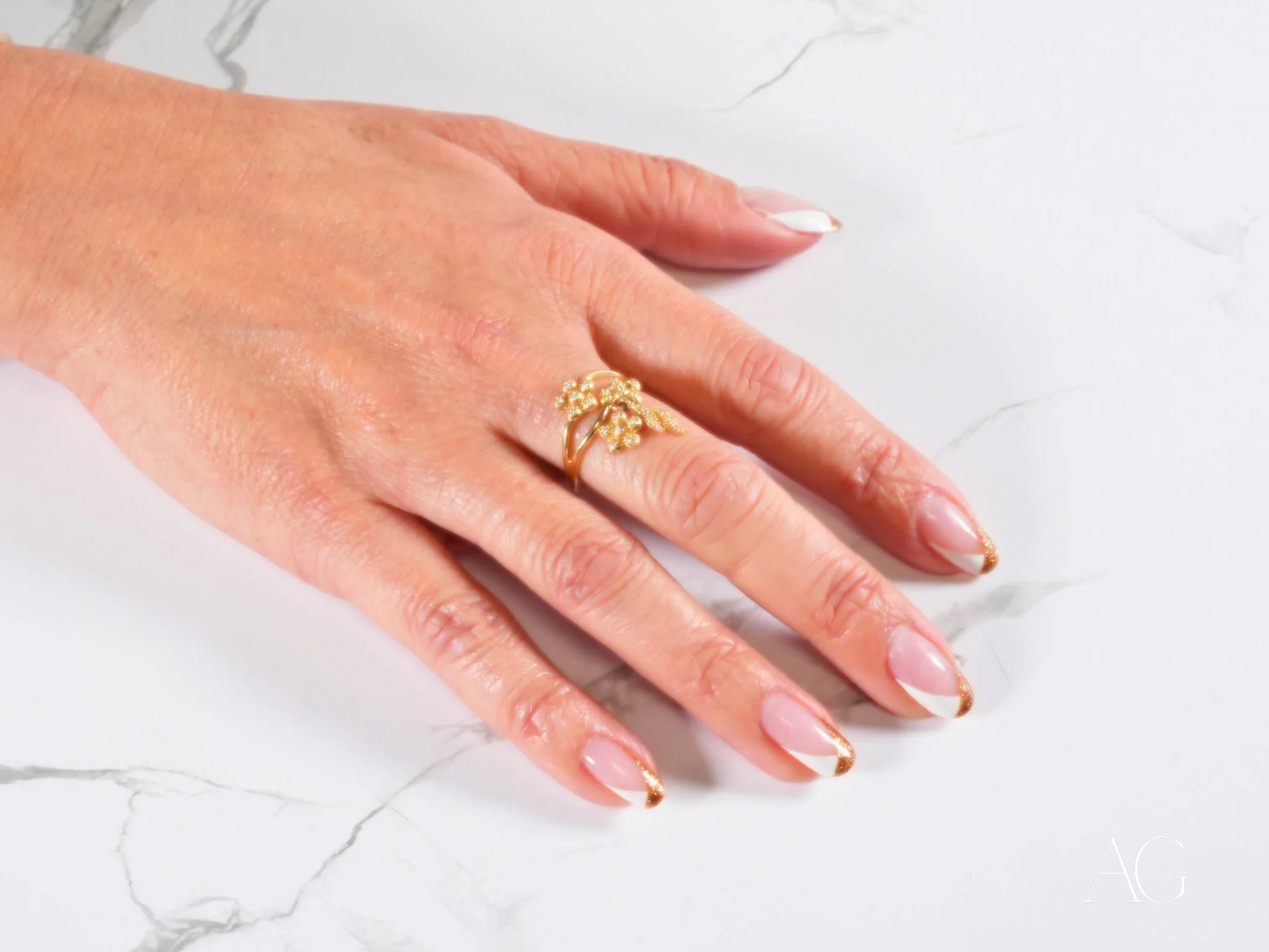 Gold Butterfly Ring on a manicured hand showcasing the Blossom Charm 18k Gold Ring