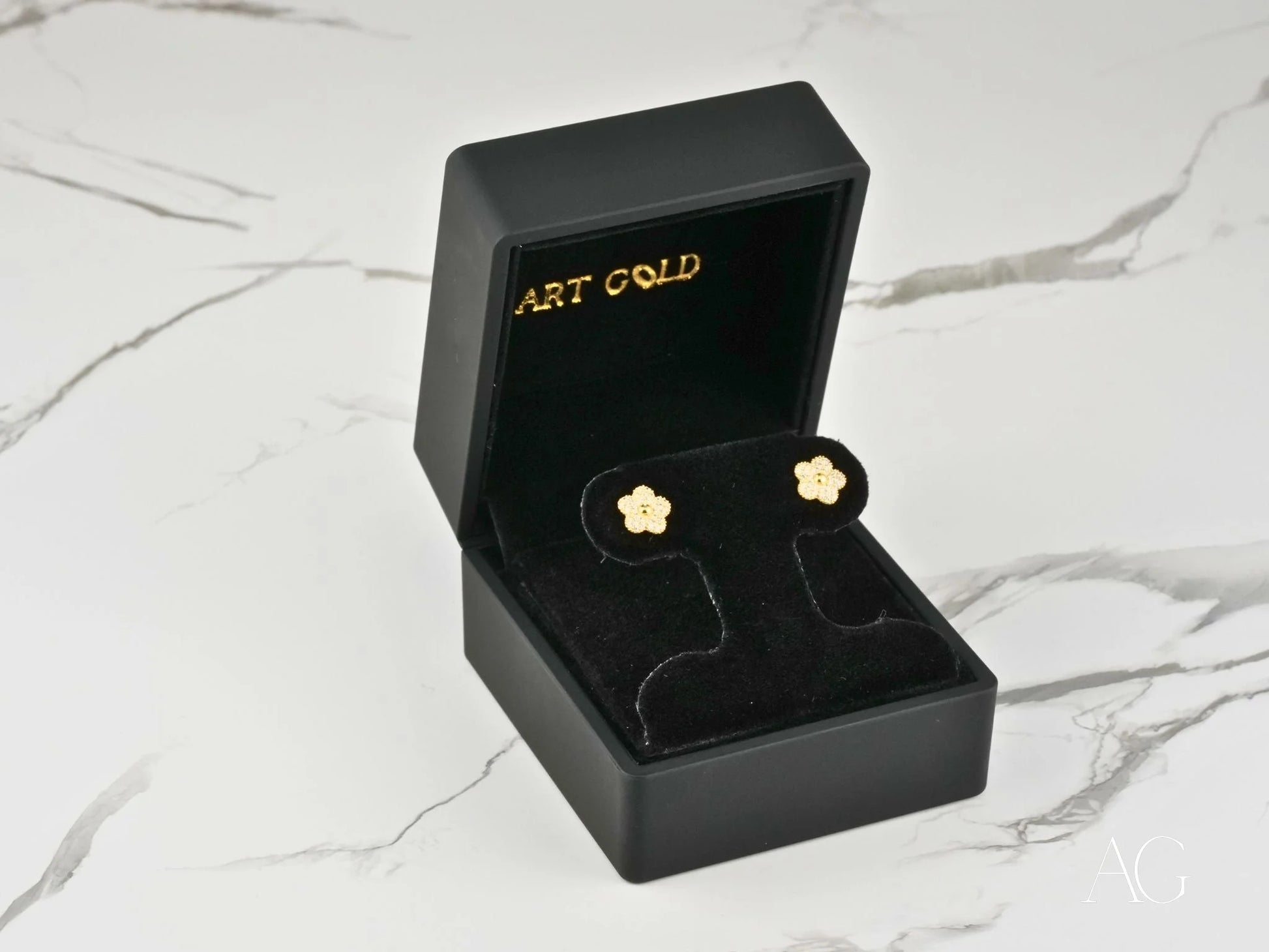 Gold CZ flower earrings in a black jewelry box from Blossom Sparkle, crafted in solid 18K gold