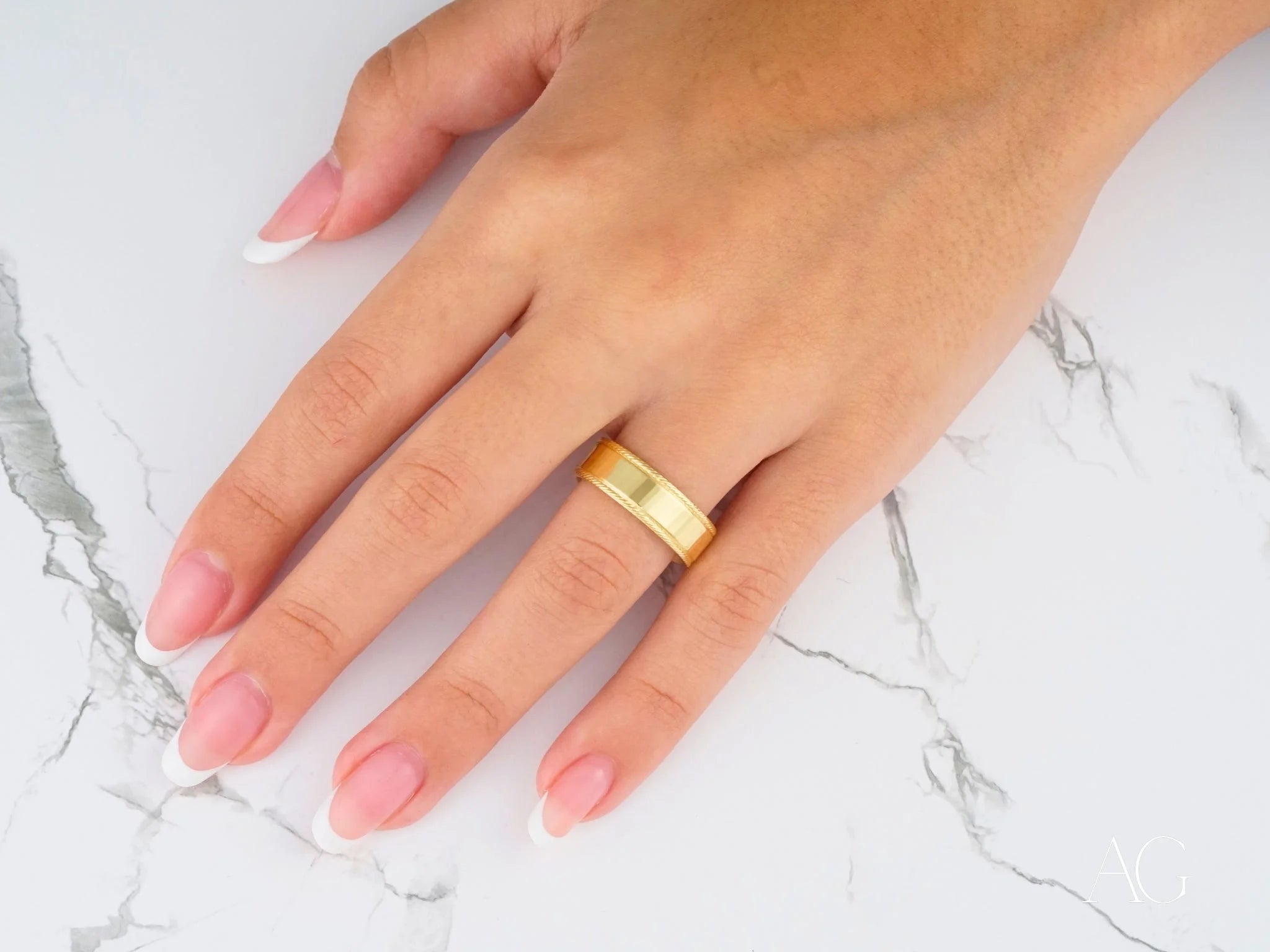 Gold wedding band on ring finger showcasing comfort fit design in 14k gold