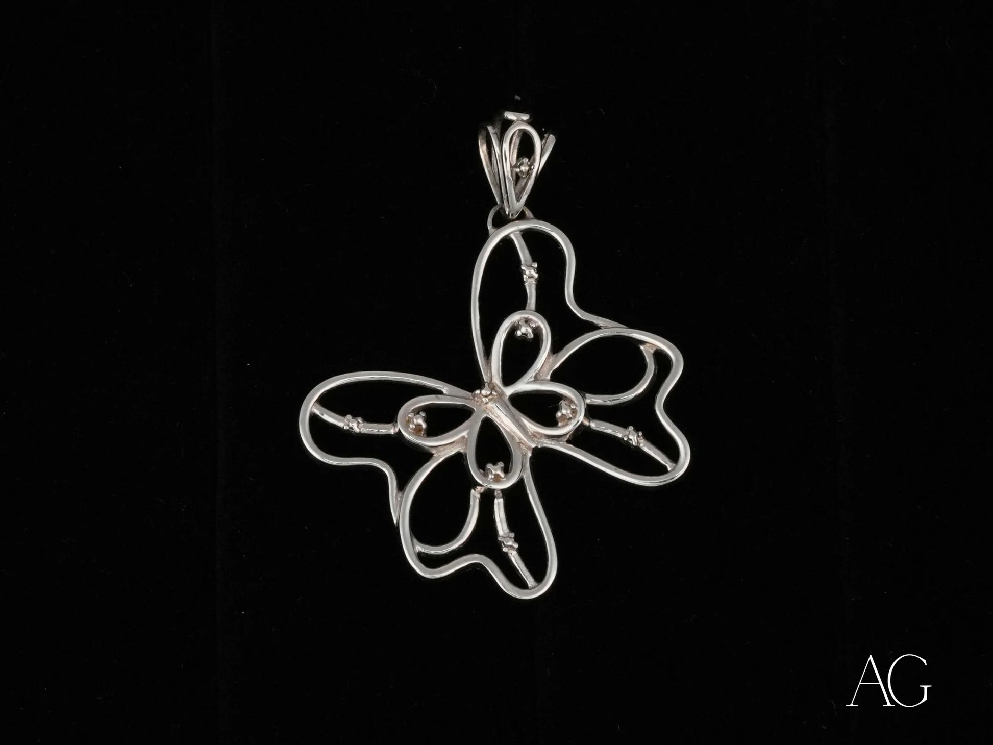 Silver wire butterfly pendant in delicate open-work design, crafted from 18k white gold