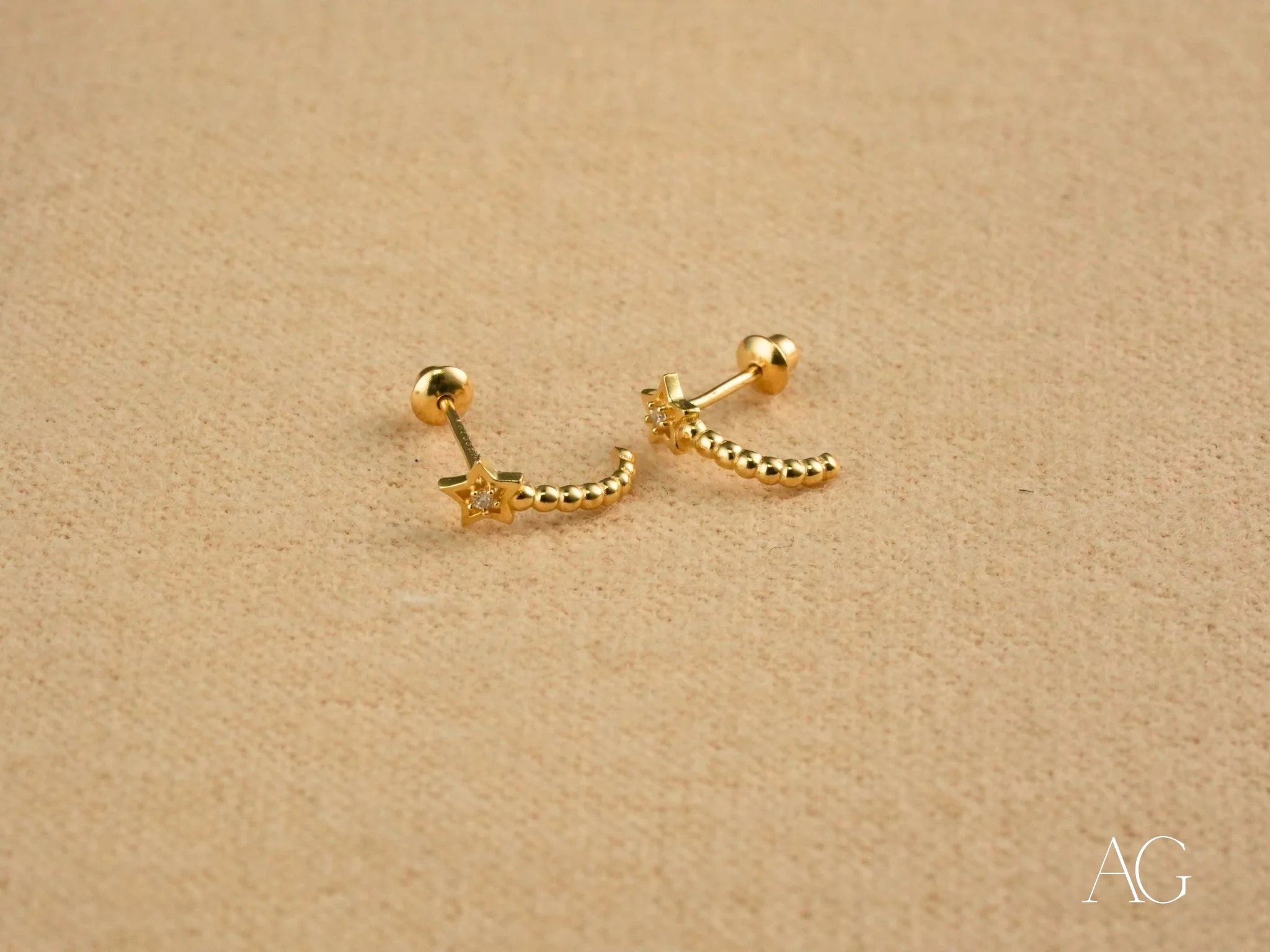 Gold Star Helix Earrings from Celestial Glow featuring a beaded crescent design