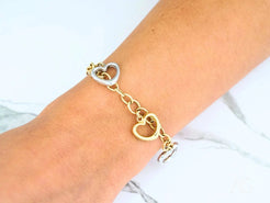 Gold and silver heart-shaped charm bracelet in 18k yellow and white gold jewelry