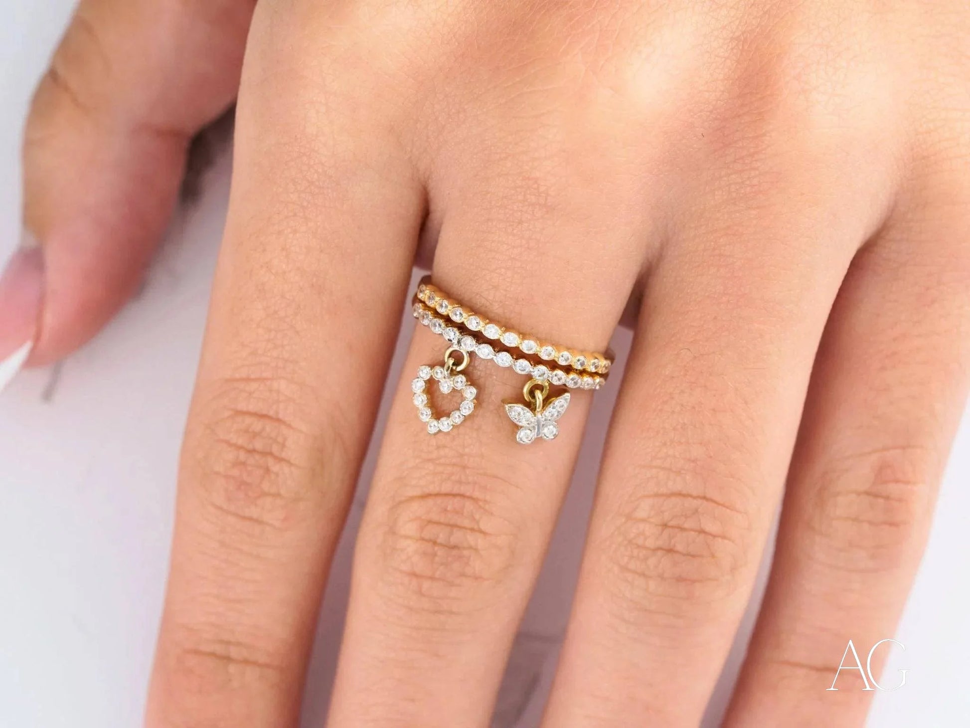 Delicate 18k yellow gold ring with heart and butterfly charms for elegant occasions