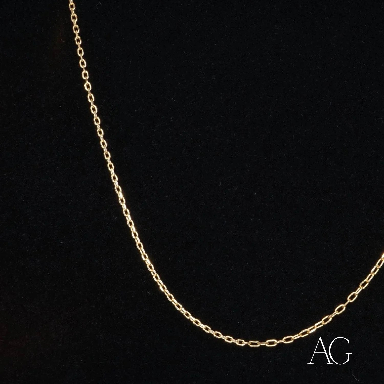 Delicate 18k gold chain necklace elegantly displayed against a dark background