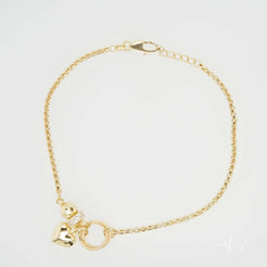 Gold-toned 18k gold bracelet with circular and heart-shaped charms and zirconia