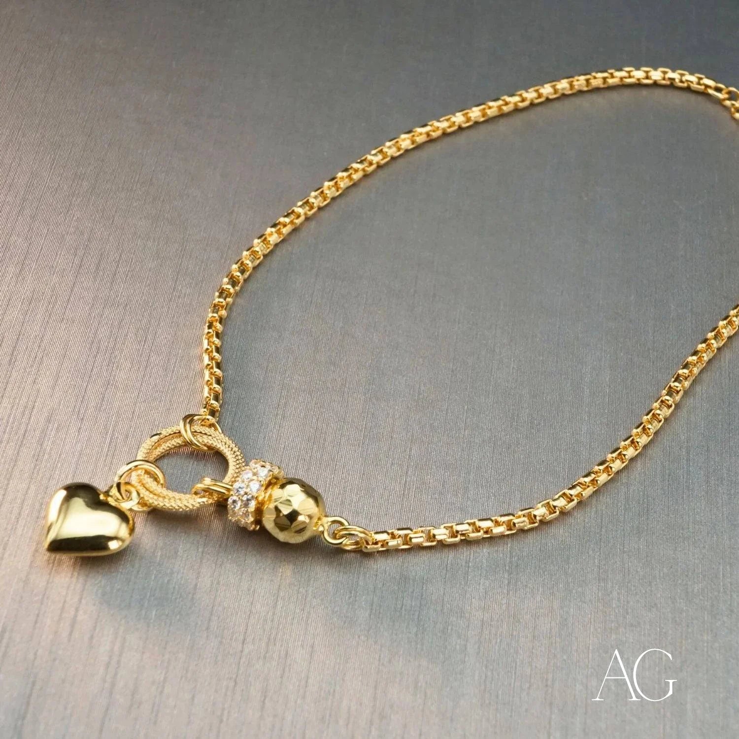 Gold necklace with heart-shaped pendant and charms, perfect for 18k gold jewelry lovers