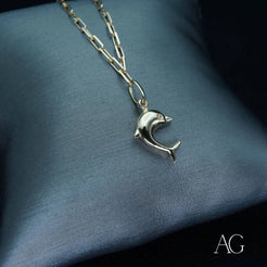 Silver dolphin-shaped pendant on delicate chain of 18k gold anklet