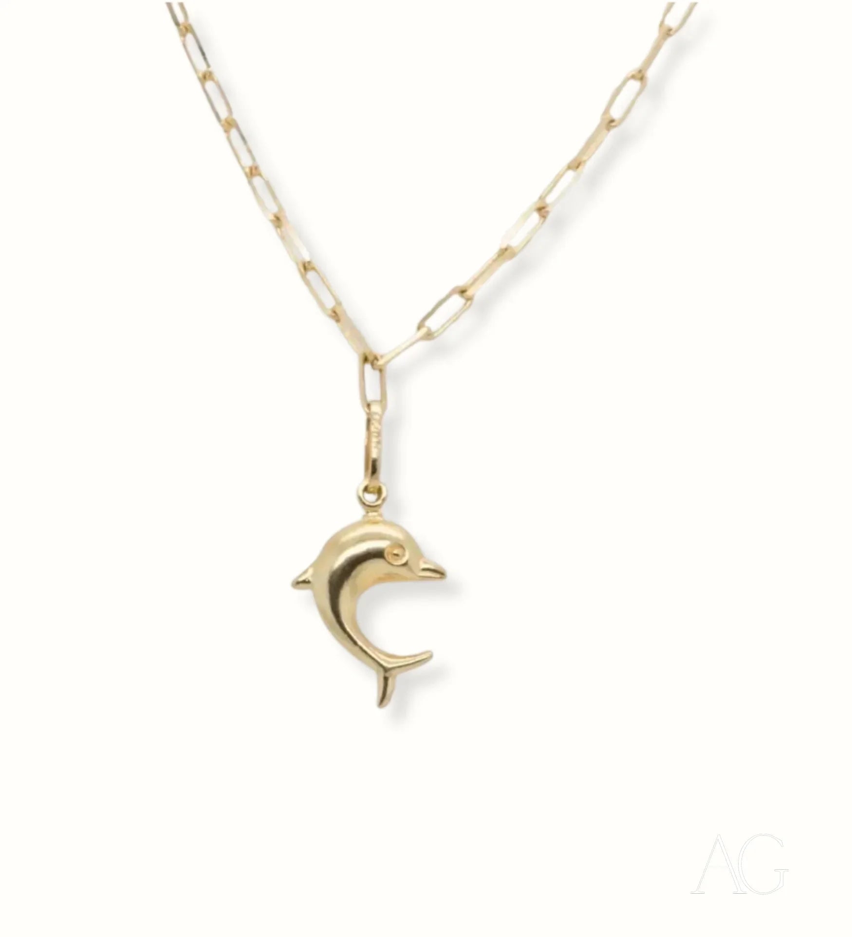 Gold dolphin-shaped pendant on delicate chain of 18k gold anklet for ocean lovers