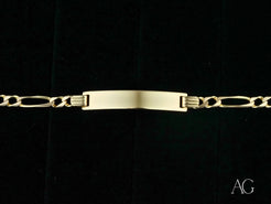 Gold-toned 18k solid gold identification bracelet with figaro chain links and nameplate