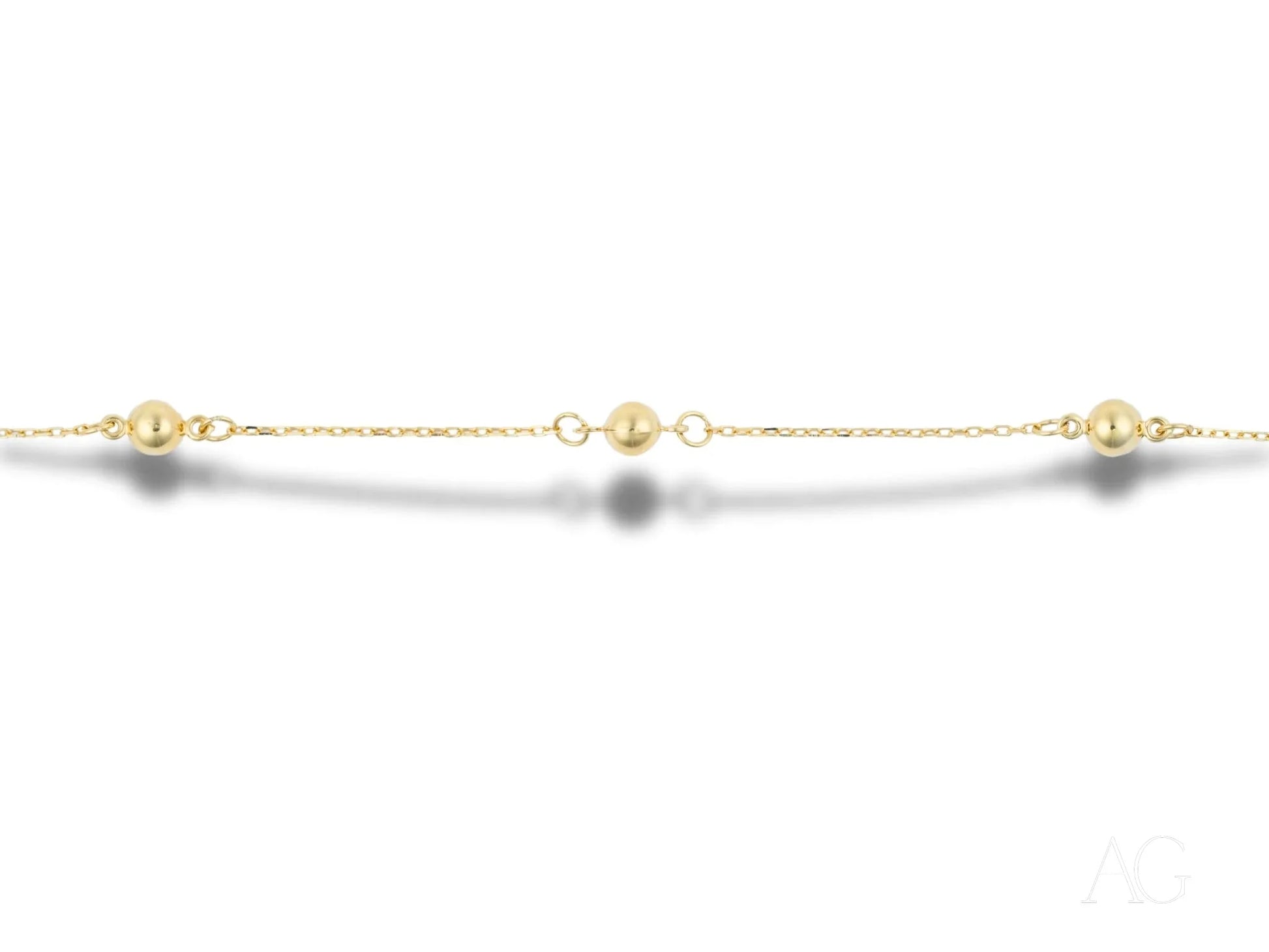 Delicate 18k gold bracelet featuring polished gold spheres and small spaced beads