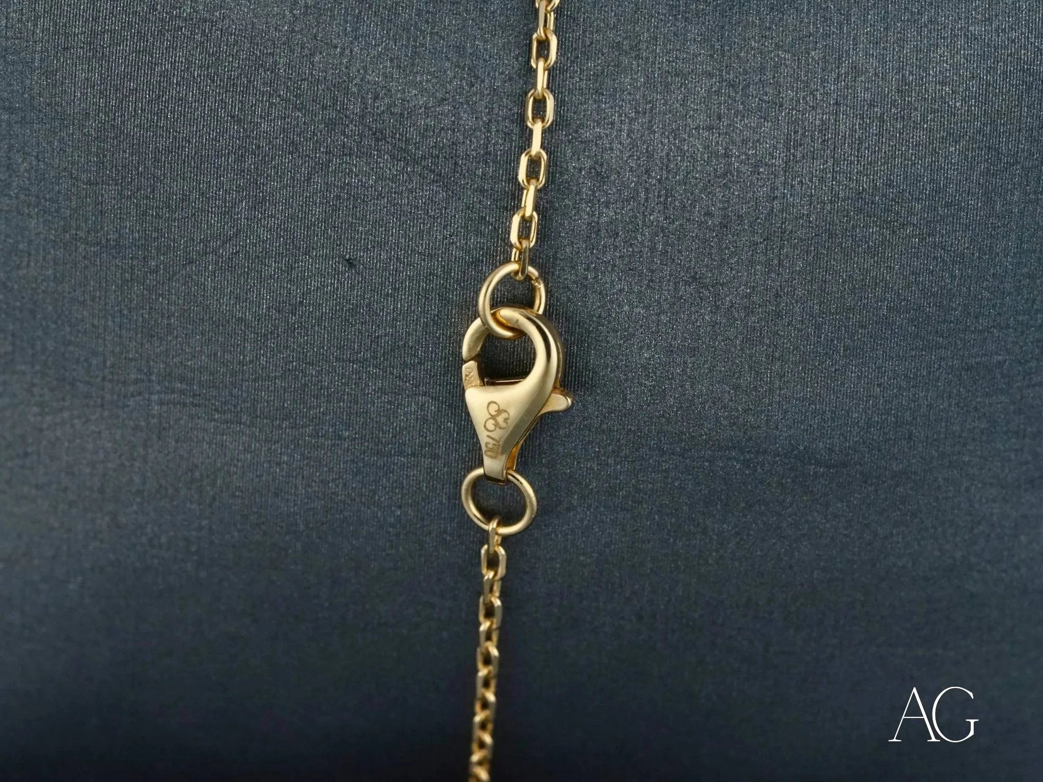 Gold lobster claw clasp on chain of Elegance and Simplicity 18k gold bracelet with polished gold spheres