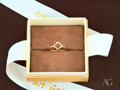 Delicate 18k flower diamond ring in a jewelry box with clover-like design