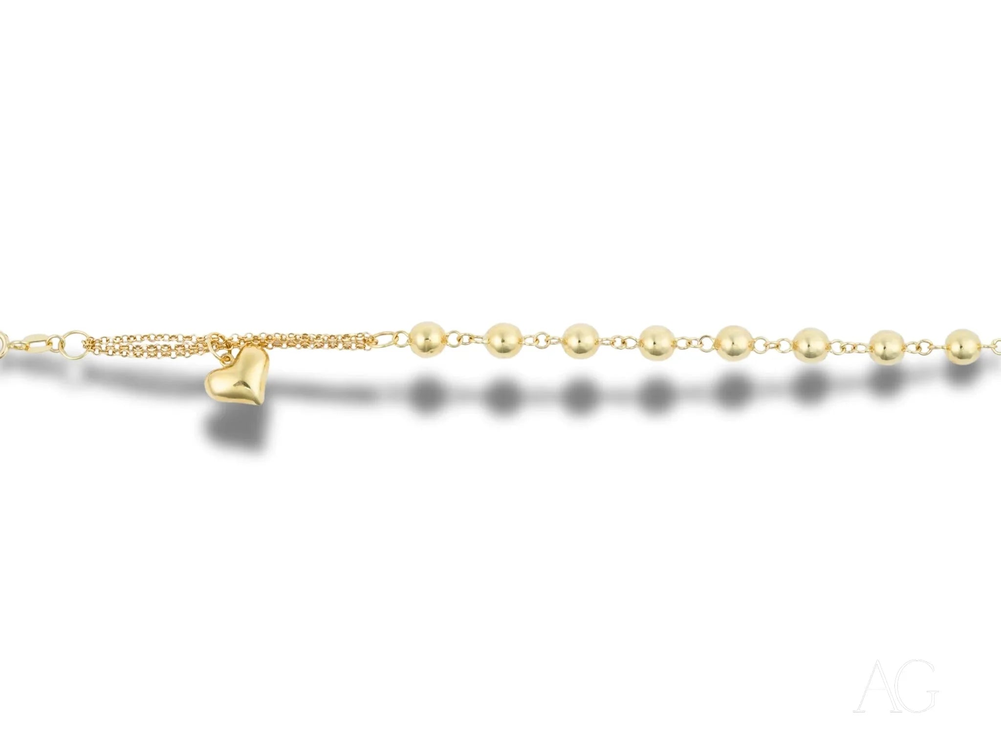 Delicate gold anklet with pearl-like beads and bell charm, featuring polished gold details