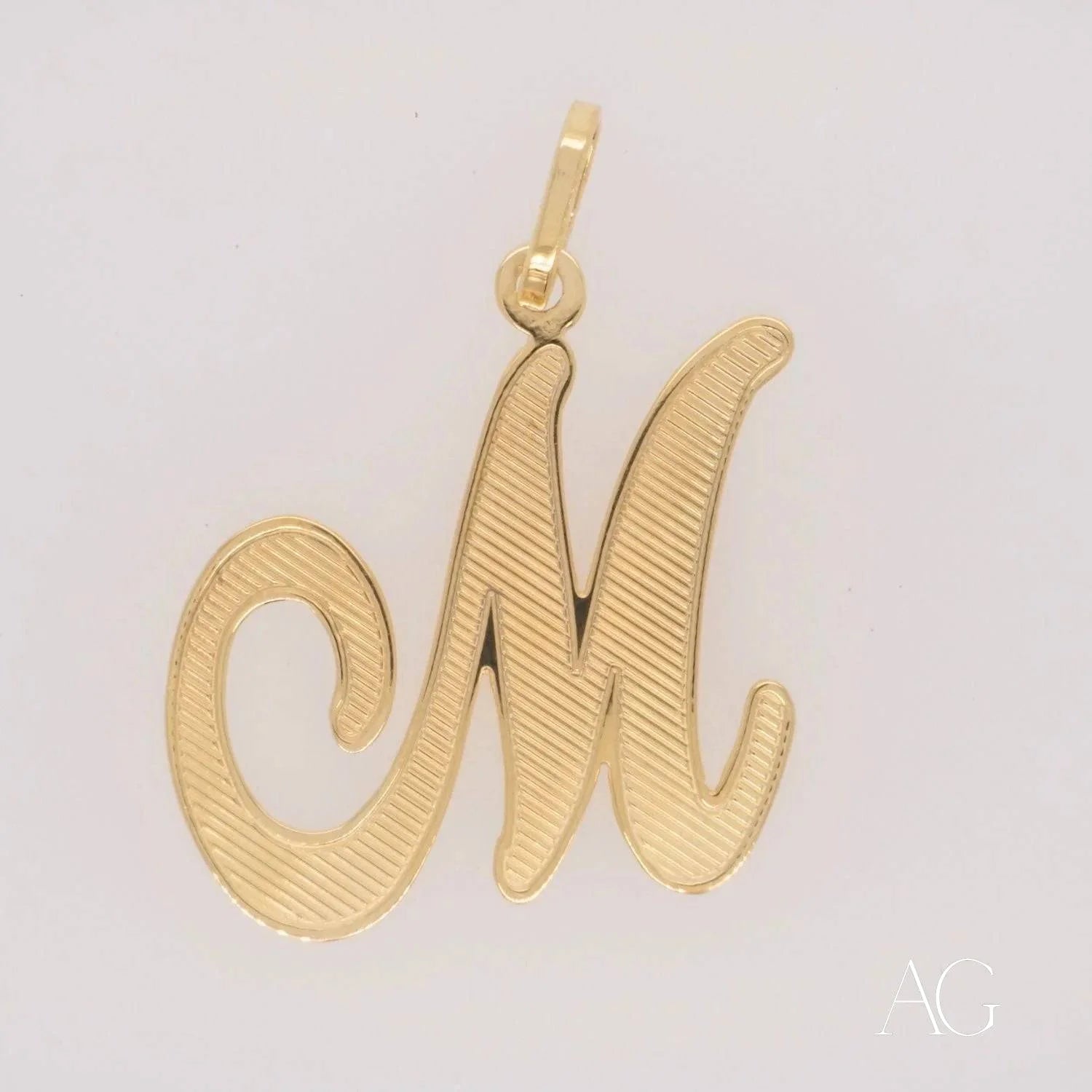 Elegant 18k Gold Letter M Pendant showcasing a stylish cursive ’M’ design