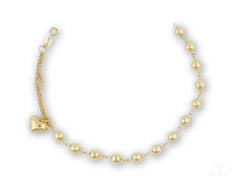 Elegant 18k gold bracelet featuring heart motif and polished gold beads with charm