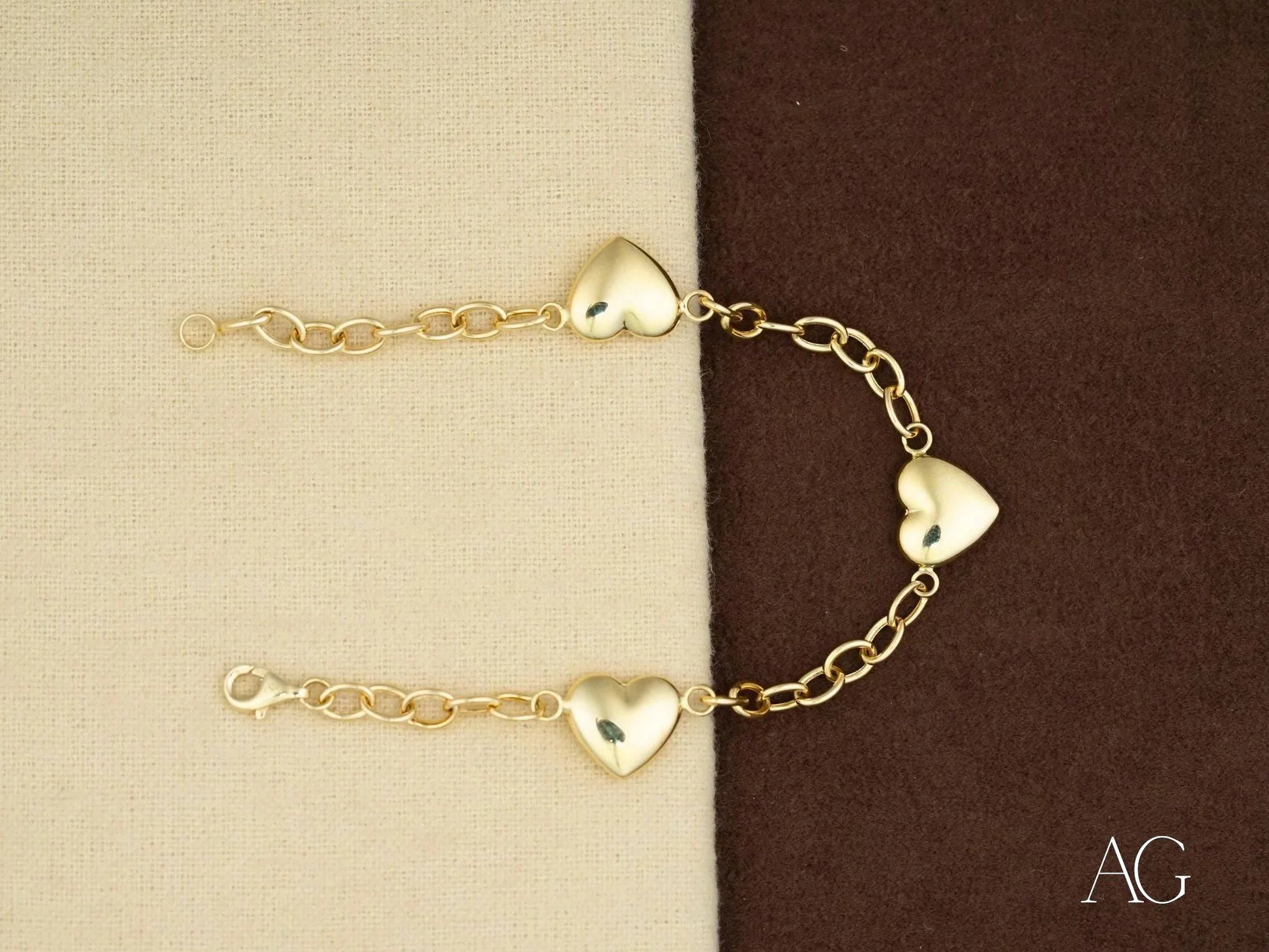 Elegant 18k gold bracelet featuring heart motifs and gold-colored chain design