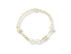 Delicate 18k gold bracelet with pearls and infinity-shaped links, adorned with cubic zirconia