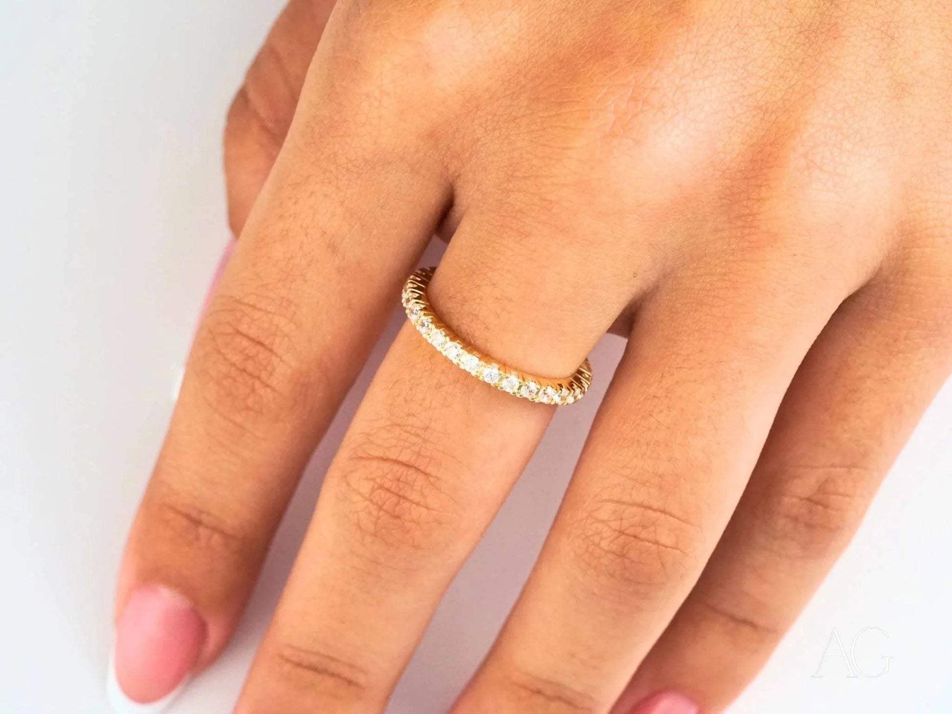 Diamond-studded 18k gold ring elegantly worn on a finger for any occasion