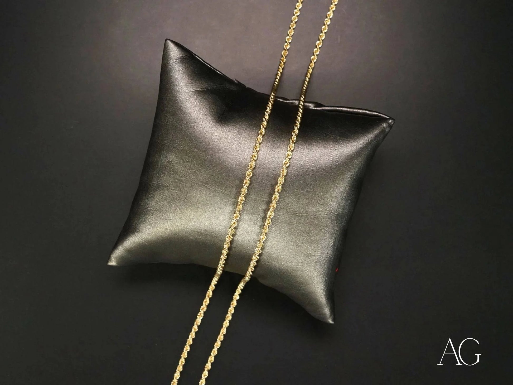 Black leather cushion displaying Elegant 14k Gold Rope Chain with secure barrel lock