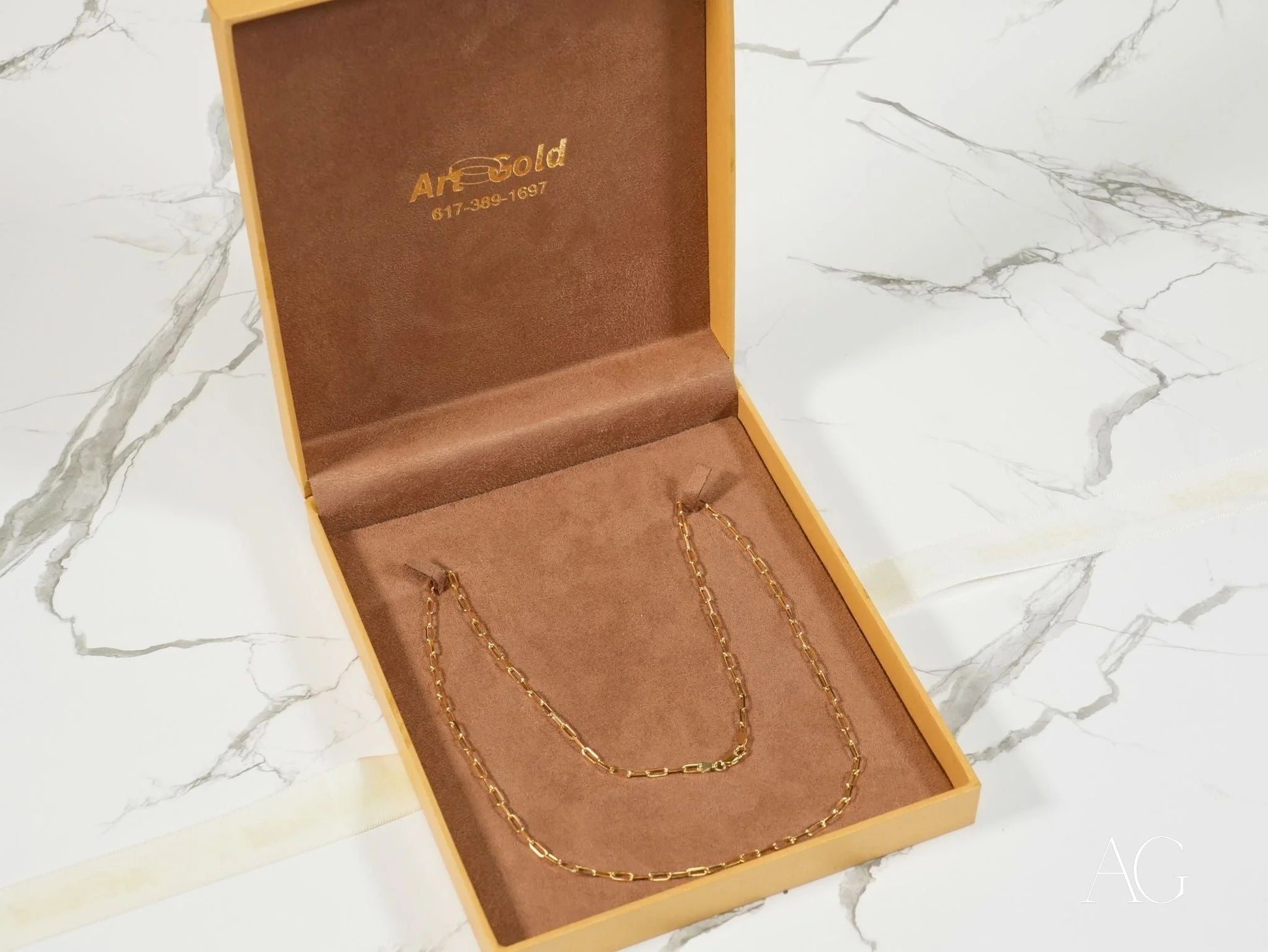 Gold chain necklace in box showcasing Elite Modernity 18K Yellow Gold Paperclip Link Chain