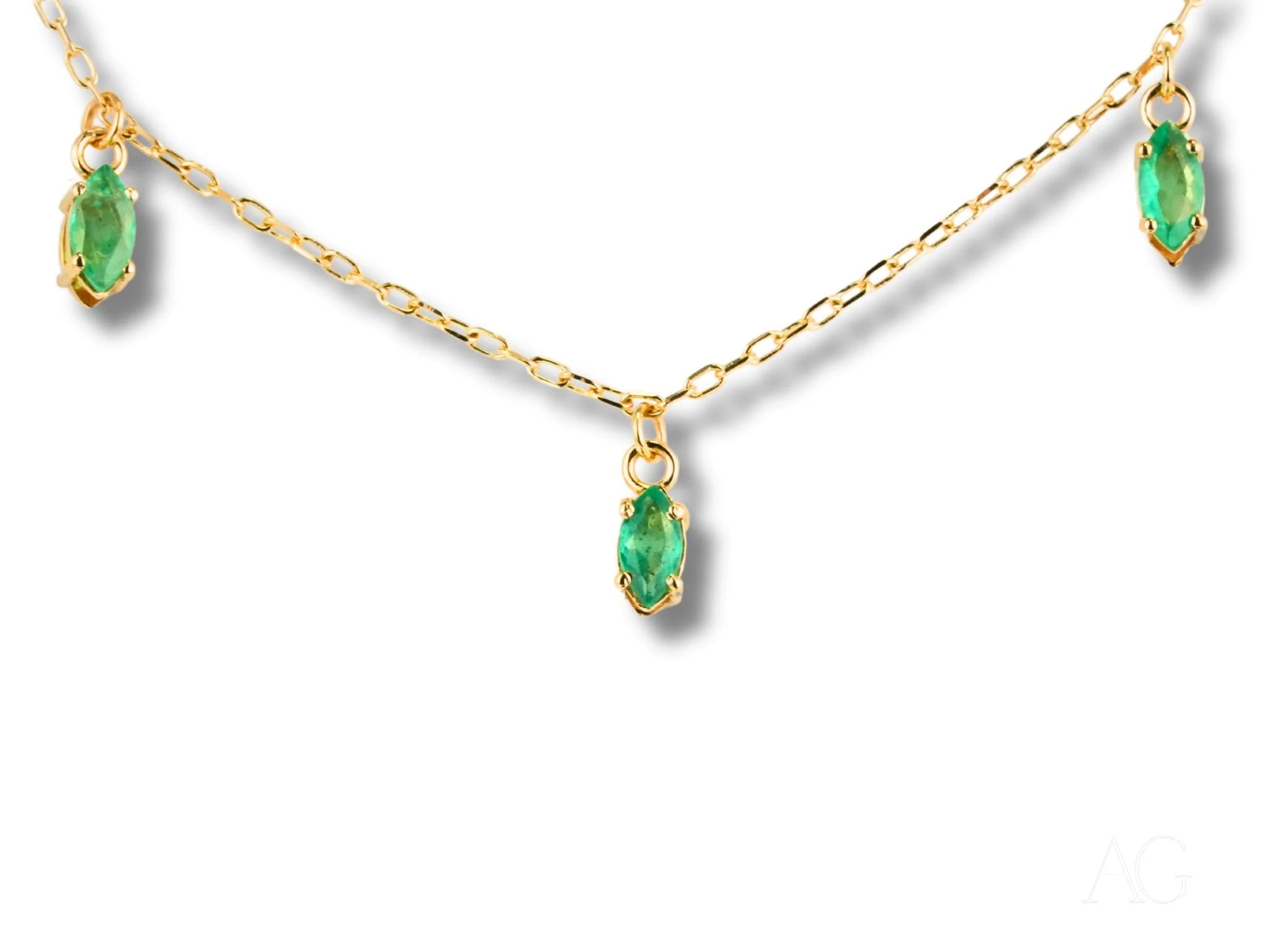 Gold chain necklace featuring marquise-cut emerald droplets in an 18k Gold Emerald Necklace