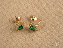 Gold halo stud earrings featuring green cubic zirconia for an emerald aura look